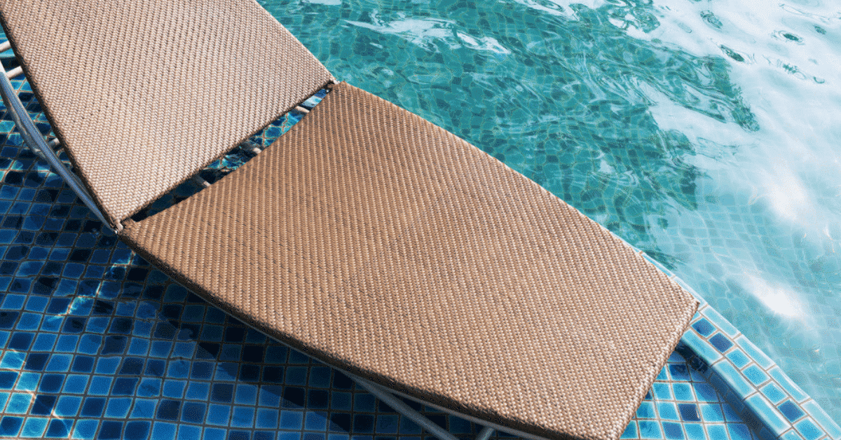 Sun shelf in a swimming pool with a chaise lounge. 