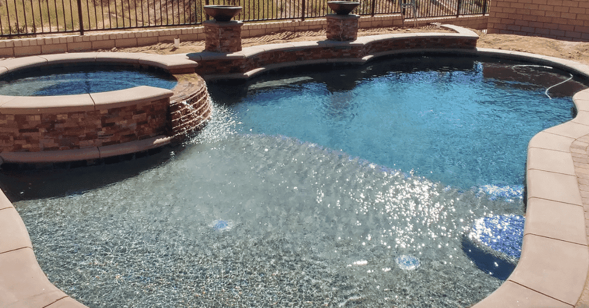 Swimming pool with a beach entry built by Thomas Pools