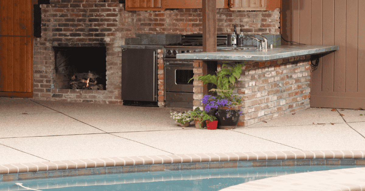 Outdoor kitchen by a swimming pool. 